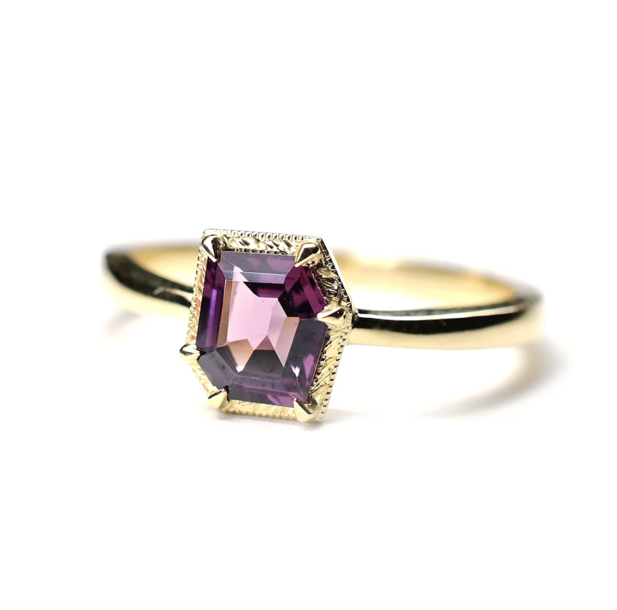 angled view of the fancy purple spinel solitaire on a white background