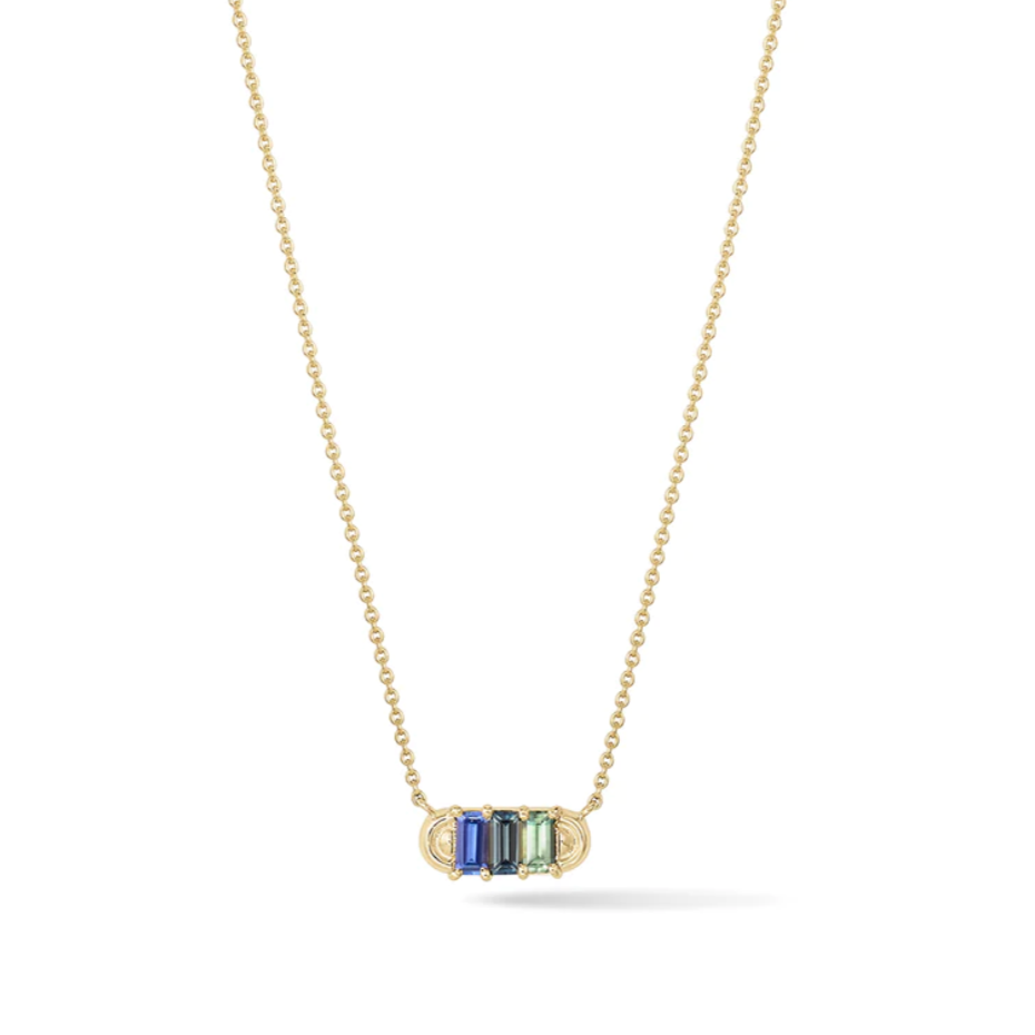 yellow gold pendant necklace with three baguette blue and green sapphires with gold arc details on each side. On a white background