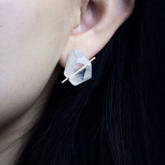 close up of a model wearing the acrylic rock earrings