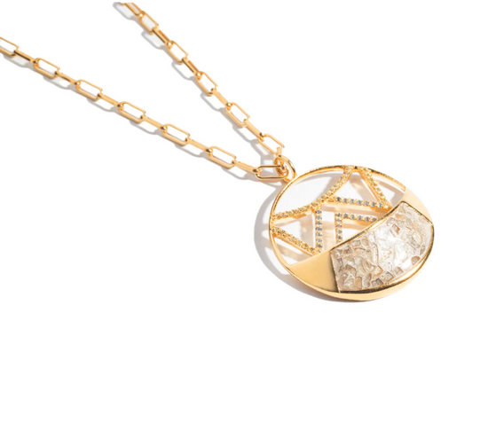 an angled view of the mini furaha pendant on a white background
