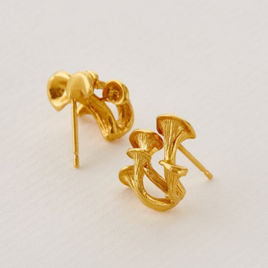 Load image into Gallery viewer, angled views of the gold magic mushroom earrings on an off white background
