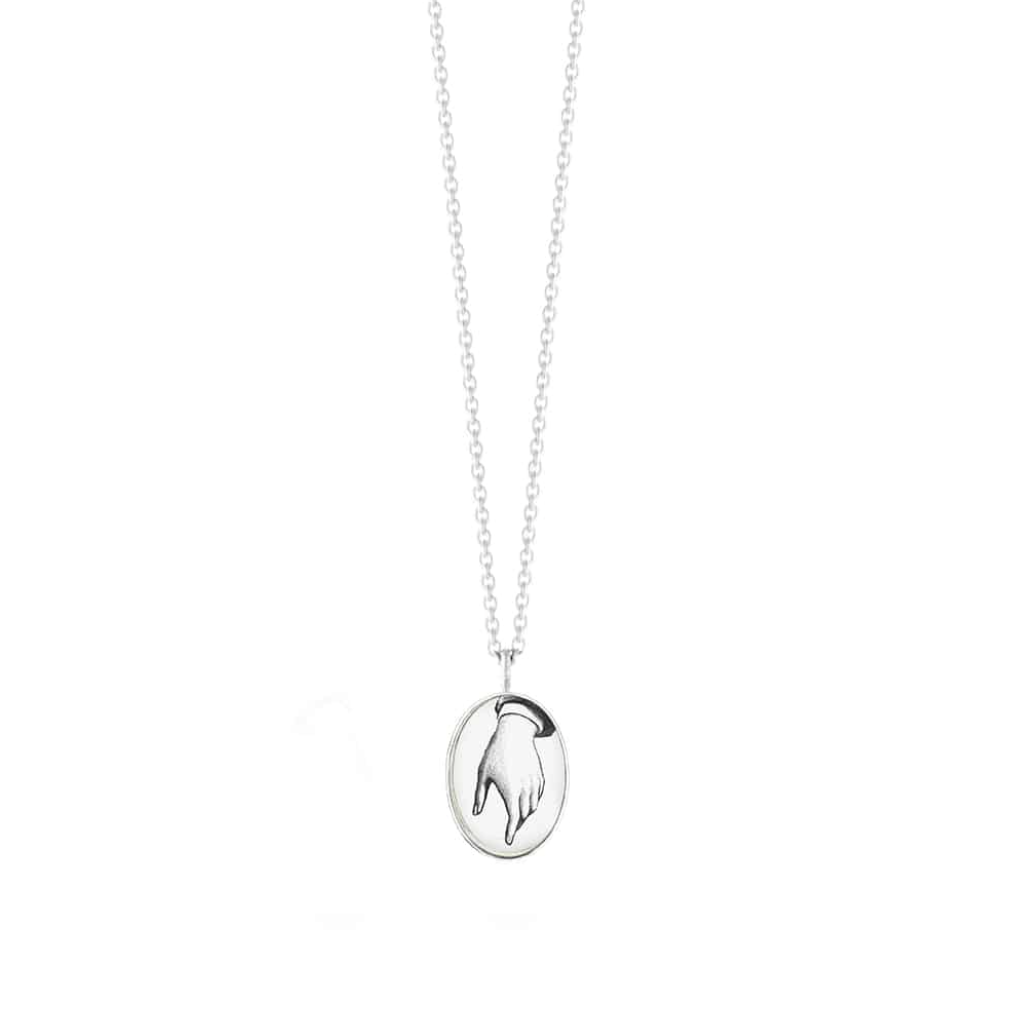 Load image into Gallery viewer, silver oval pendant necklace with hand drawn hand motif on white background
