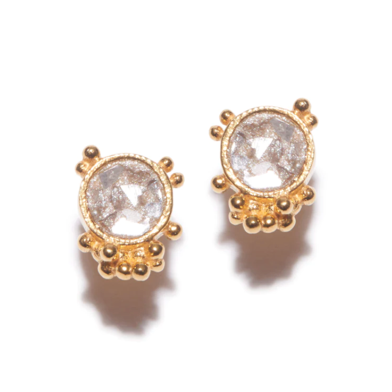 small circle shaped diamond studs set in gold with small gold ball accents on a white background
