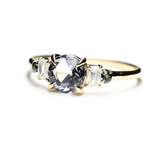 angled view of the five stone spinel ring on a white background