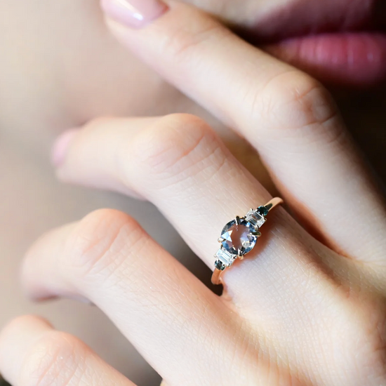 close up of a model wearing the five stone spinel ring on middle finger