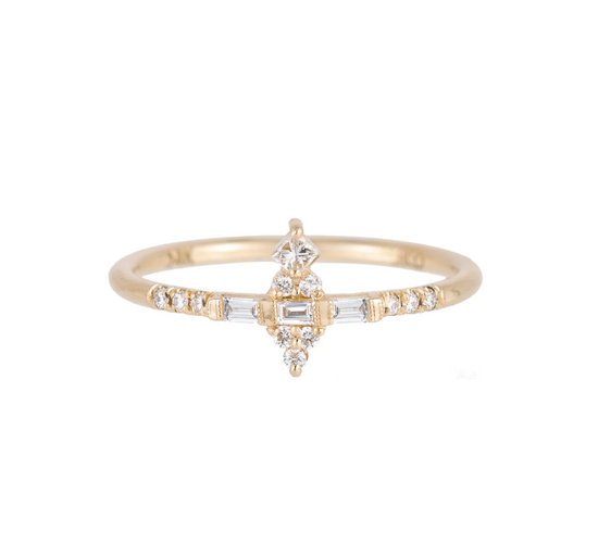 a 14k yellow gold ring with a mix of baguette and round white diamonds set on a white background