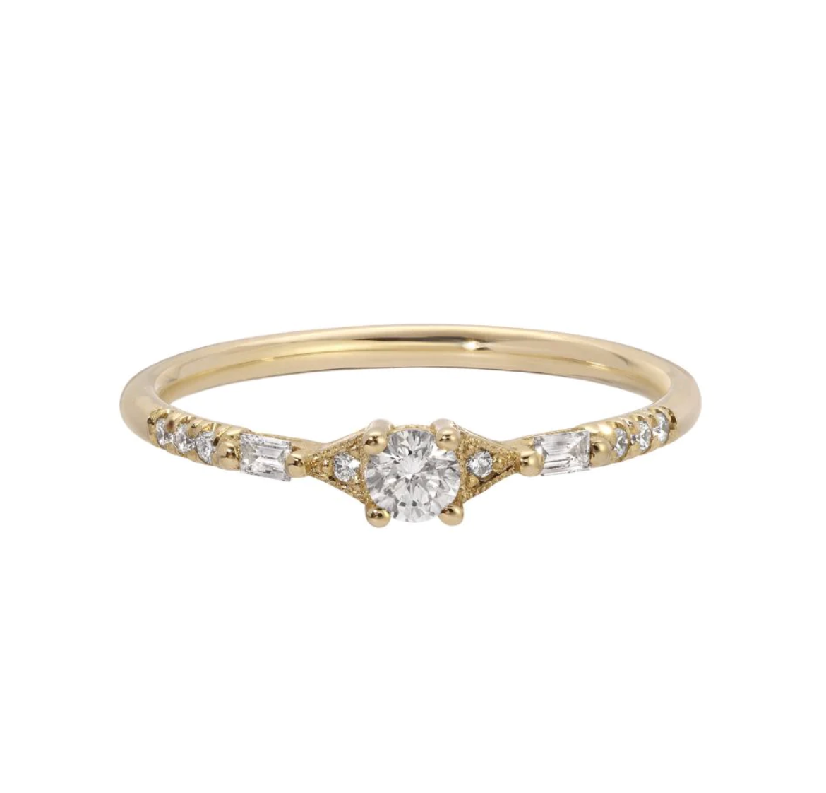 a gold diamond ring with round and baguette diamonds and delicate metal details on a white background