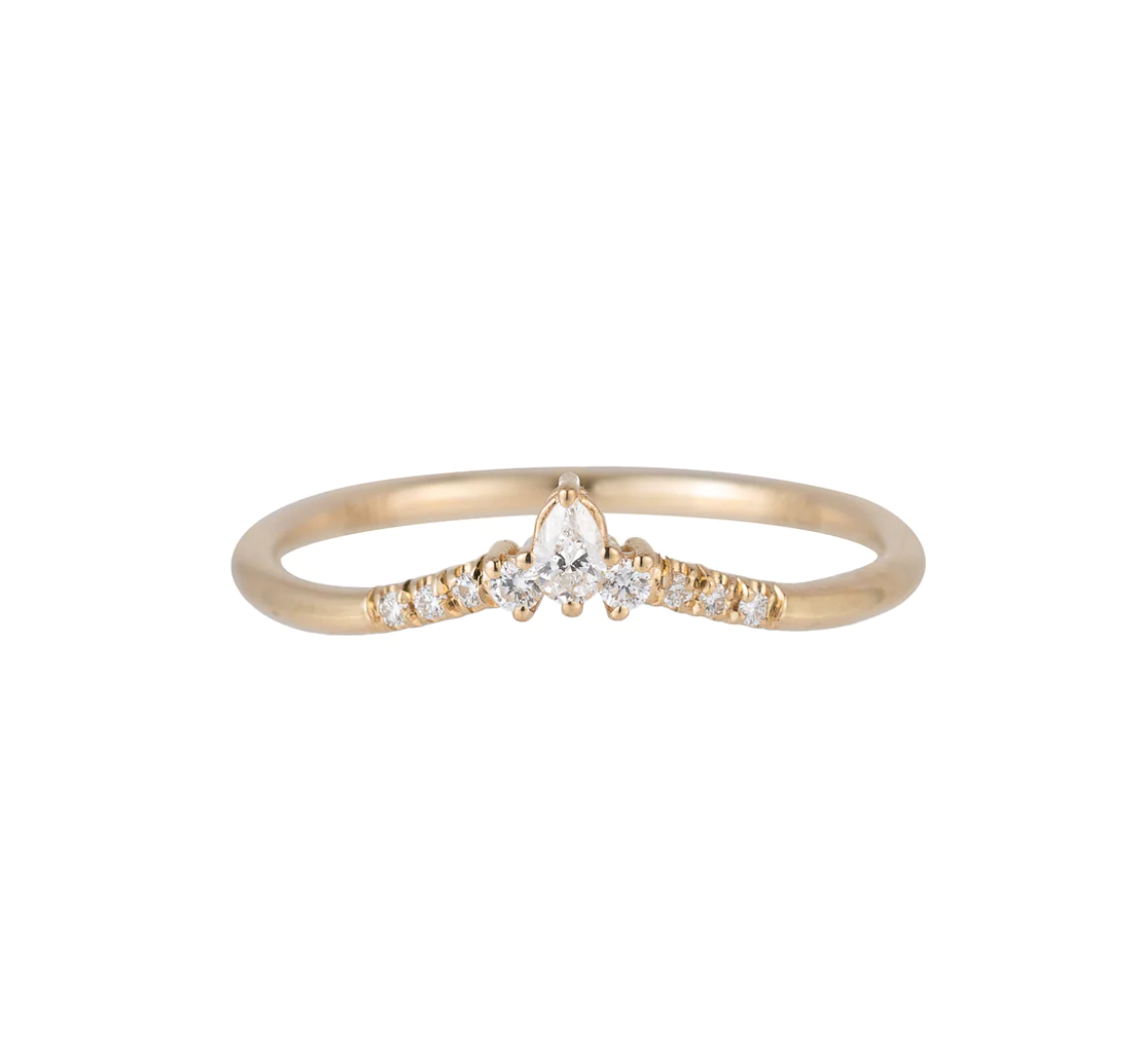a slightly curved gold band with round white diamonds leading to a pear shaped diamond in the center on a white background