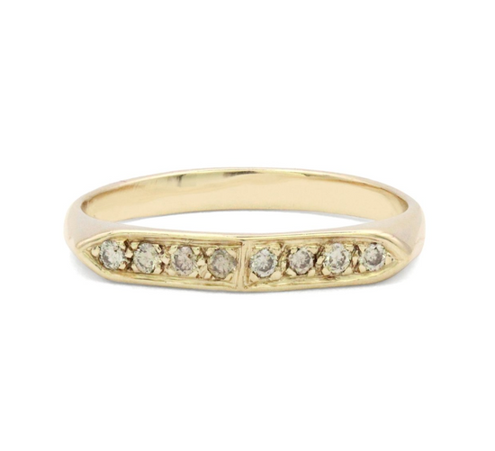 gold tapered band with 8 champagne diamonds on a white background