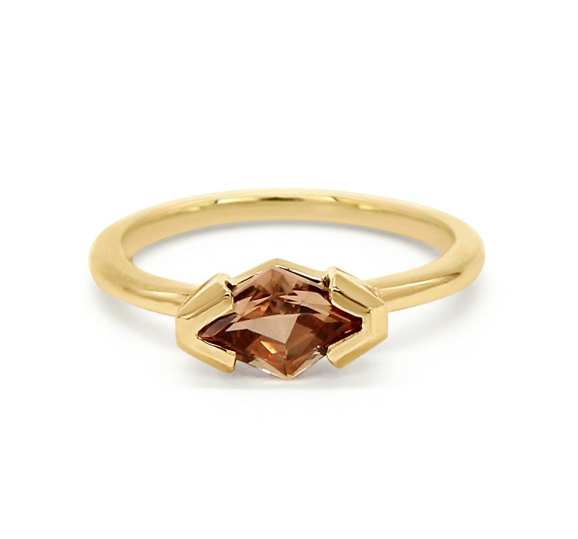 fancy kite shaped topaz set in a 14k half bezel solitaire on a white background