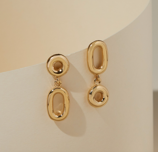 leon earrings on beige background