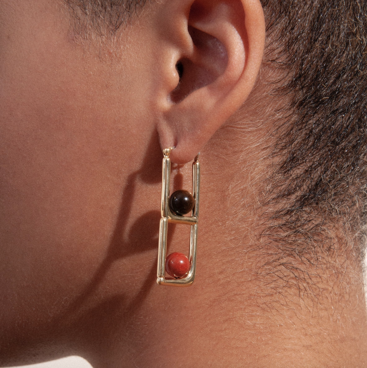 close up of a model wearing the tiered earrings