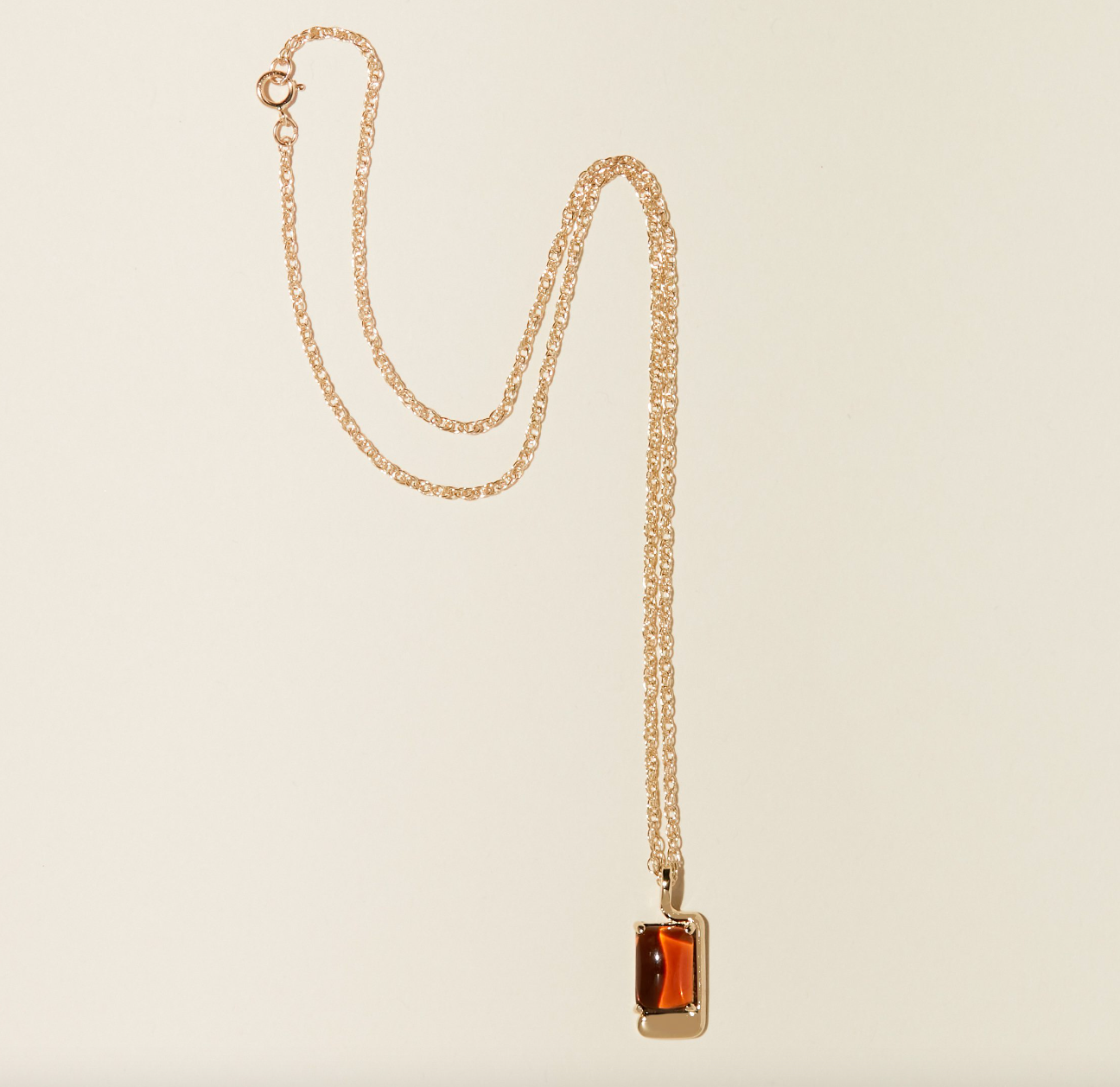 foster necklace on beige background