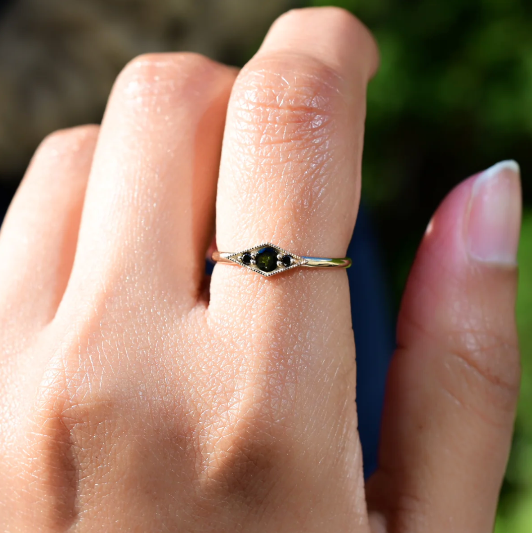 close up of a model wearing the shillay ring with bi-color tourmaline on pointer finger