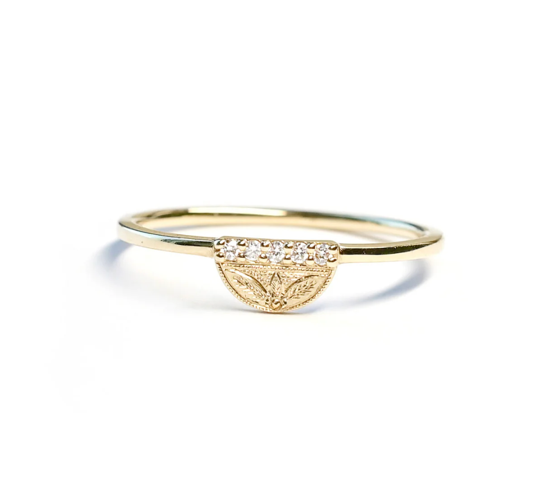 hand engraved half moon signet with hand engraving and white diamond accents on a white background