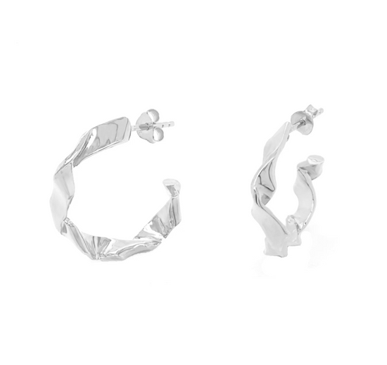 silver colored textured wave hoops on white background