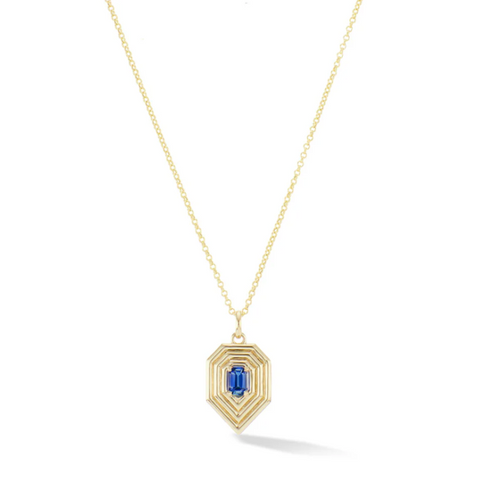 geometric tear drop shape gold pendant necklace with emerald cut blue sapphire center stone on a white background