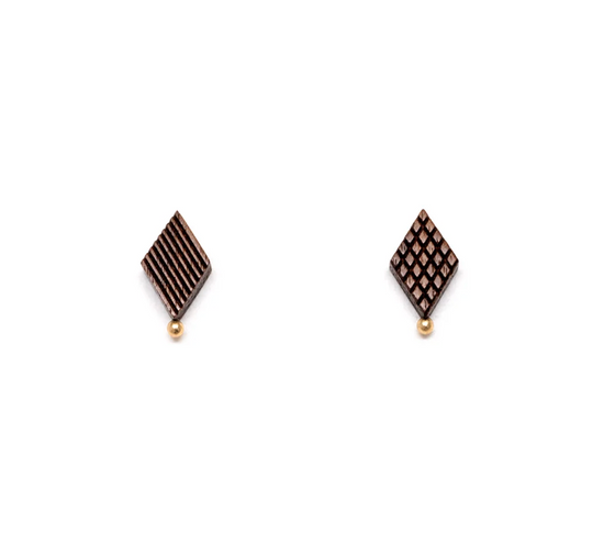 diamond shaped wooden studs with mismatched engravings and a gold ball detail on a white background