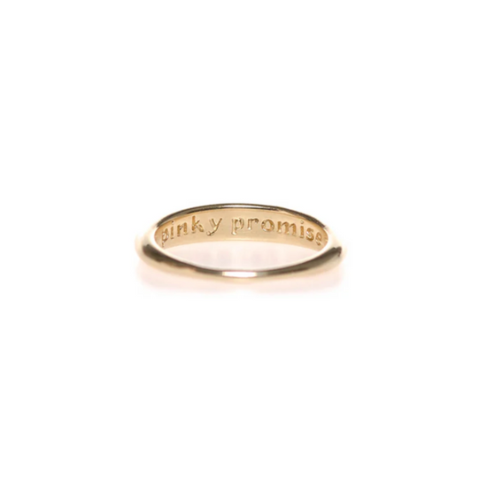 inside view of the pinky promise ring, showing the engraving "pinky promise" on a white background