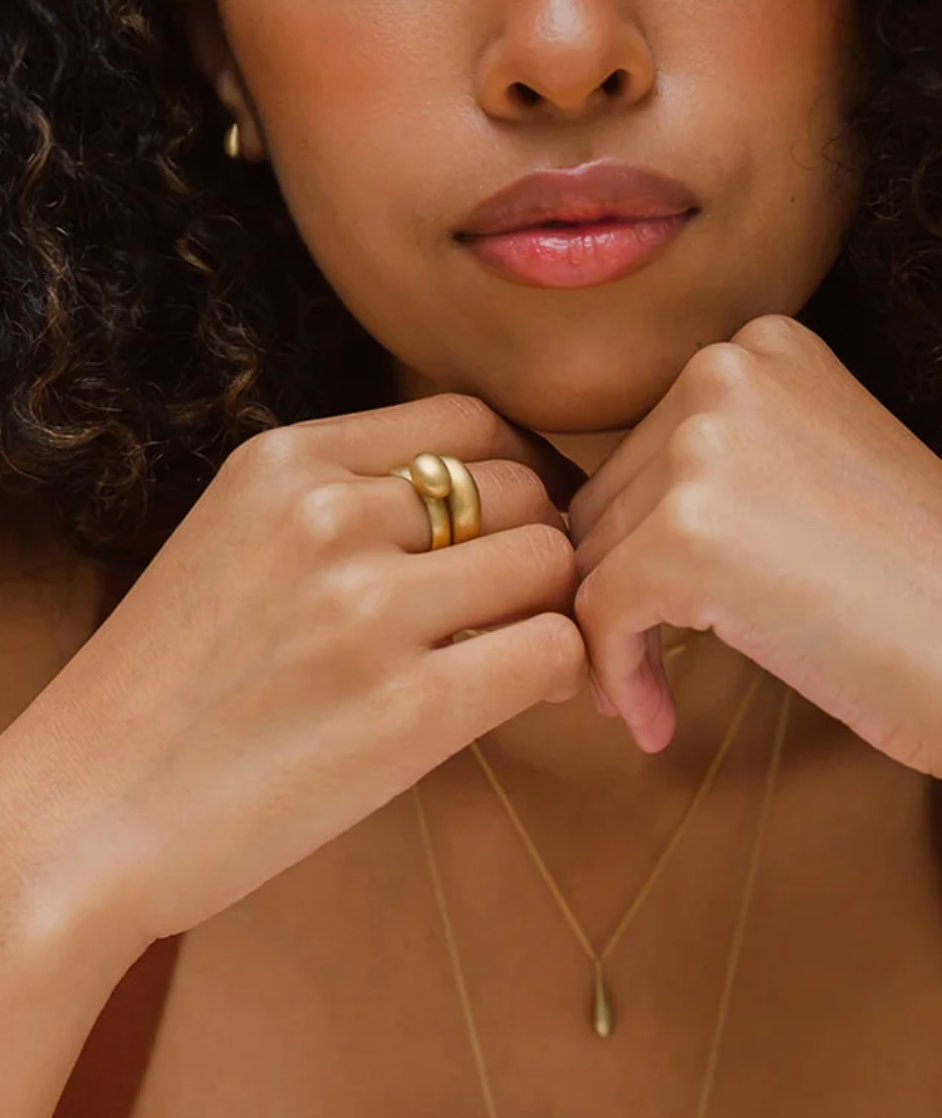 model wearing the domed ring stacked with another gold ring