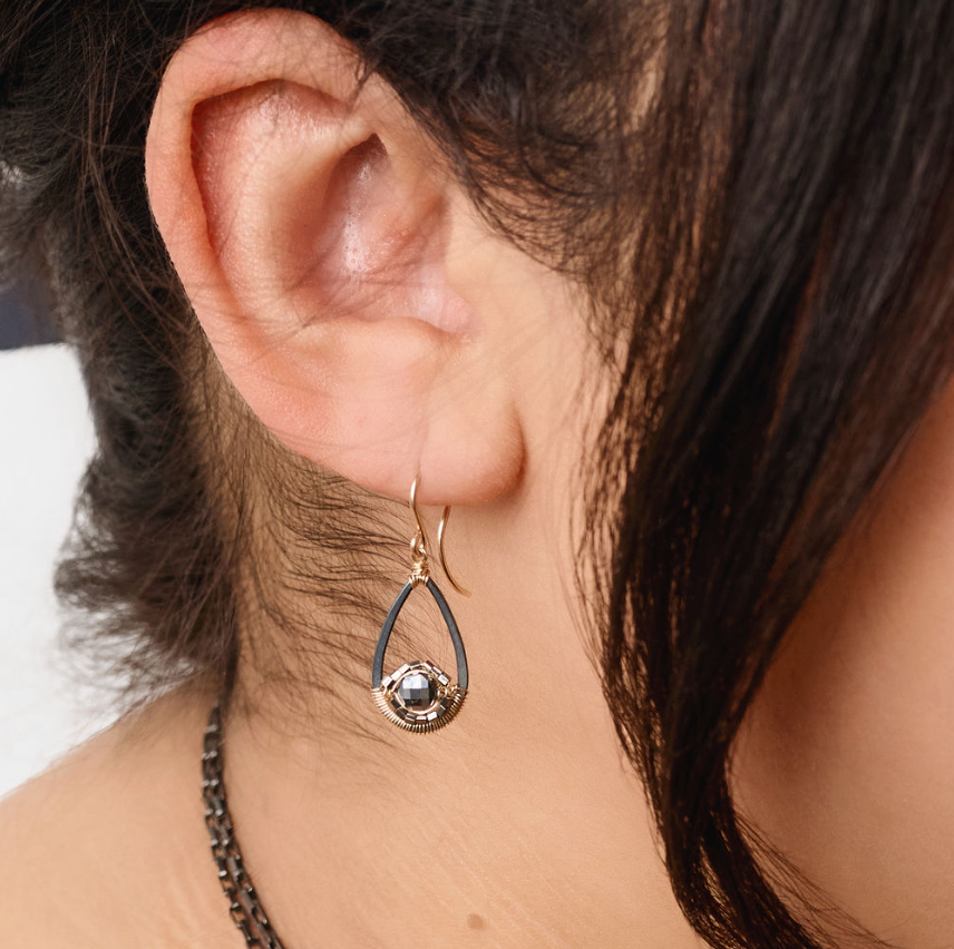 close up of a model wearing the black spinel drop earrings