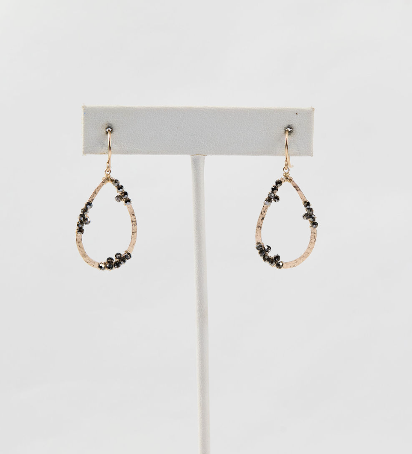 cluster bead drop earrings on white earring stand on white background