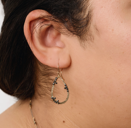 close up of model wearing the beaded cluster drop earrings