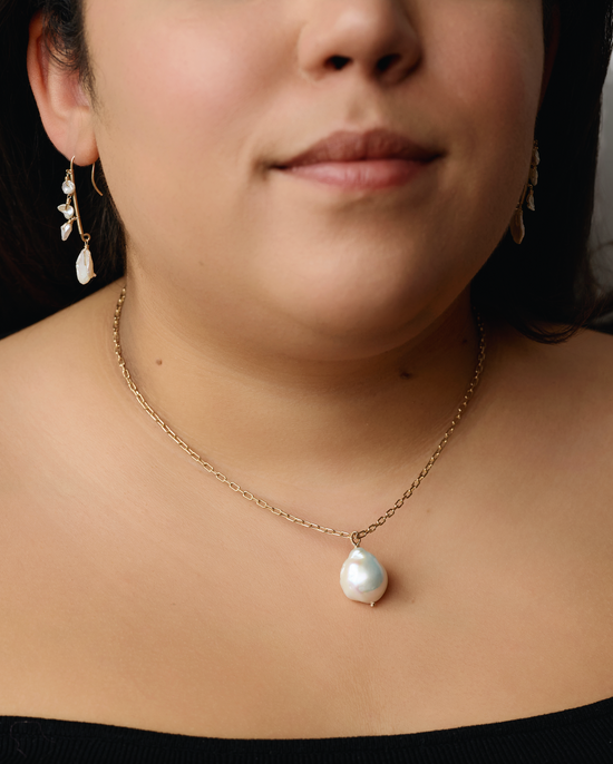 model wearing the pearl drop necklace and pearl drop earrings