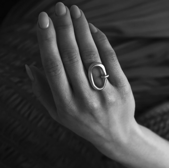 black and white photo of a model wearing the silver ring on their ring finger