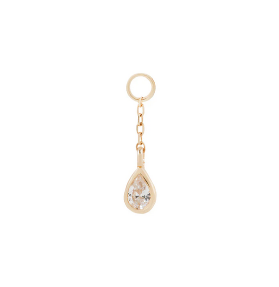 small gold earring charm with a pear shaped crystal on a white background