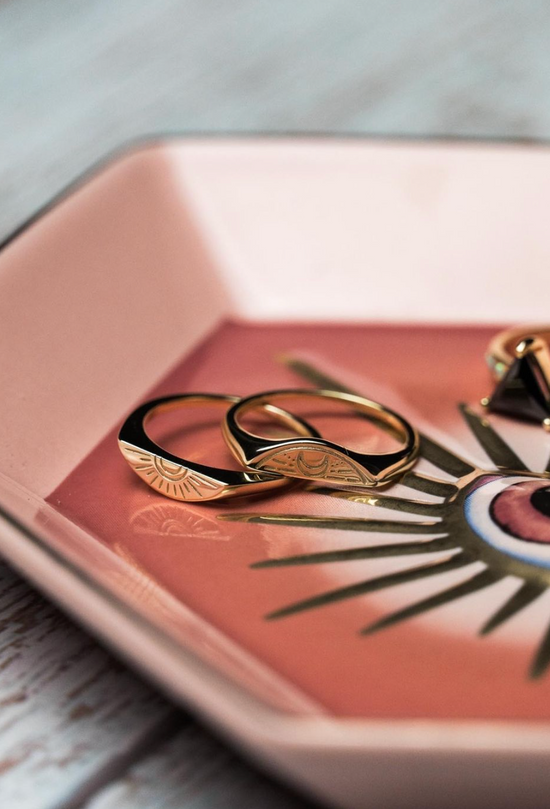 close up view of the pink eye trinket dish holding jewelry