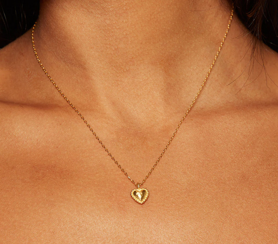 close up of a model wearing the got heart pendant necklace