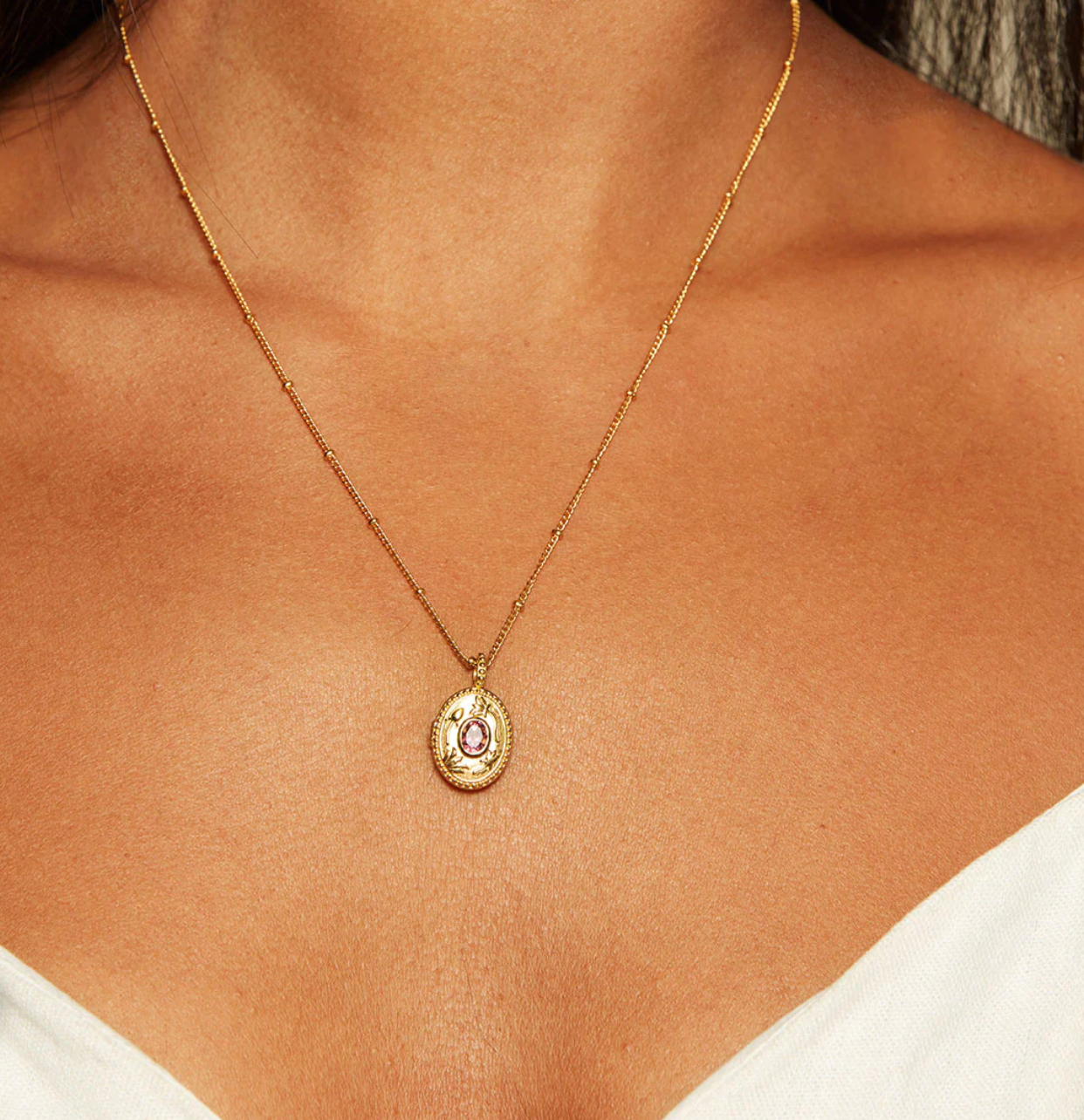 close up of a model wearing the lotus garnet locket