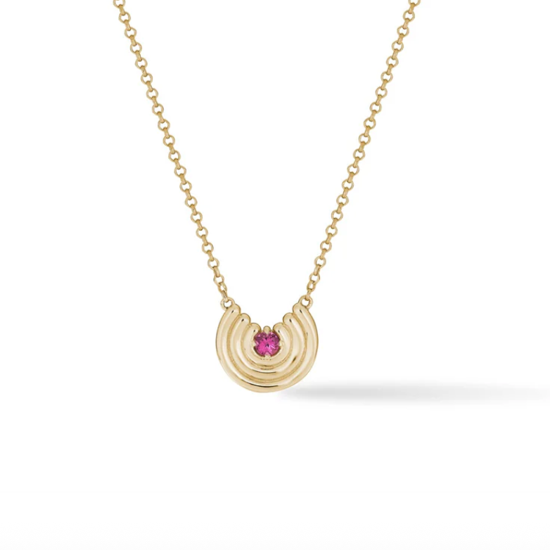 Gold necklace with a pink tourmaline gemstone pendant on a white background