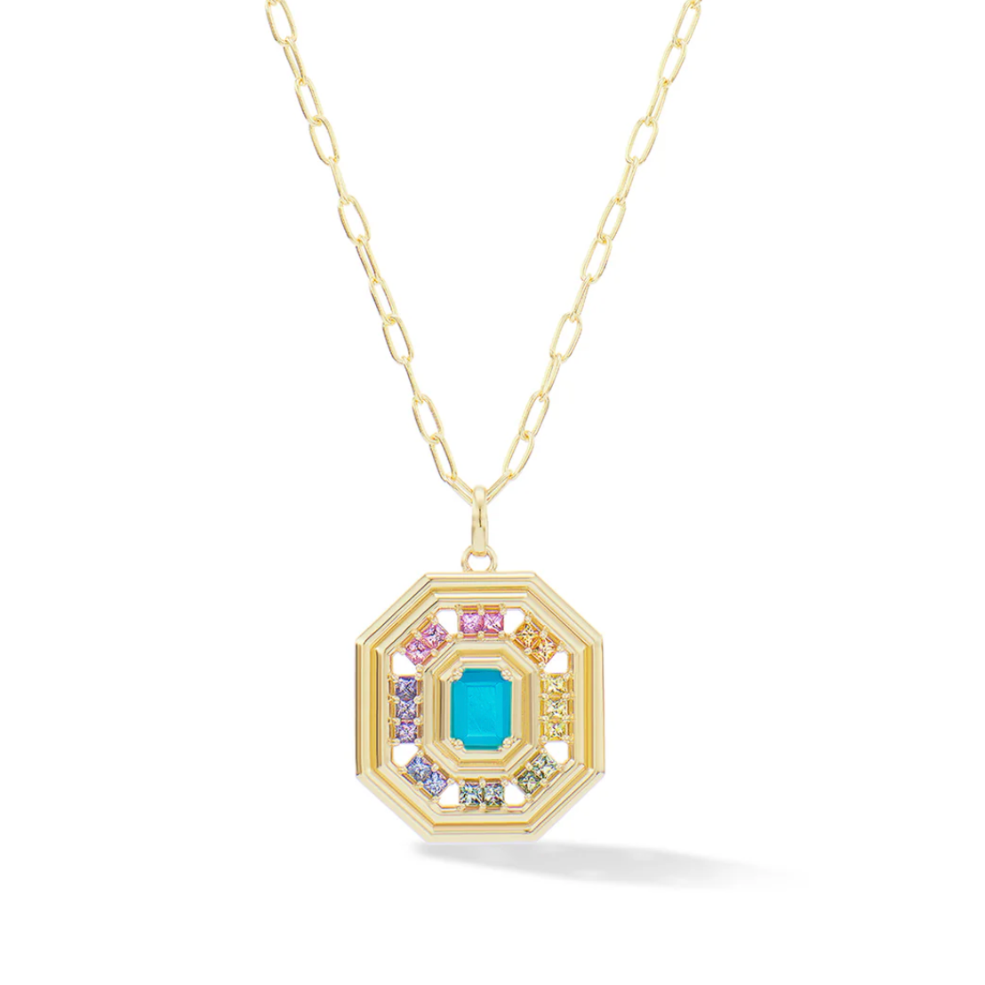 Gold necklace with a colorful pendant of rainbow sapphires surrounding a turquoise gem on a white background