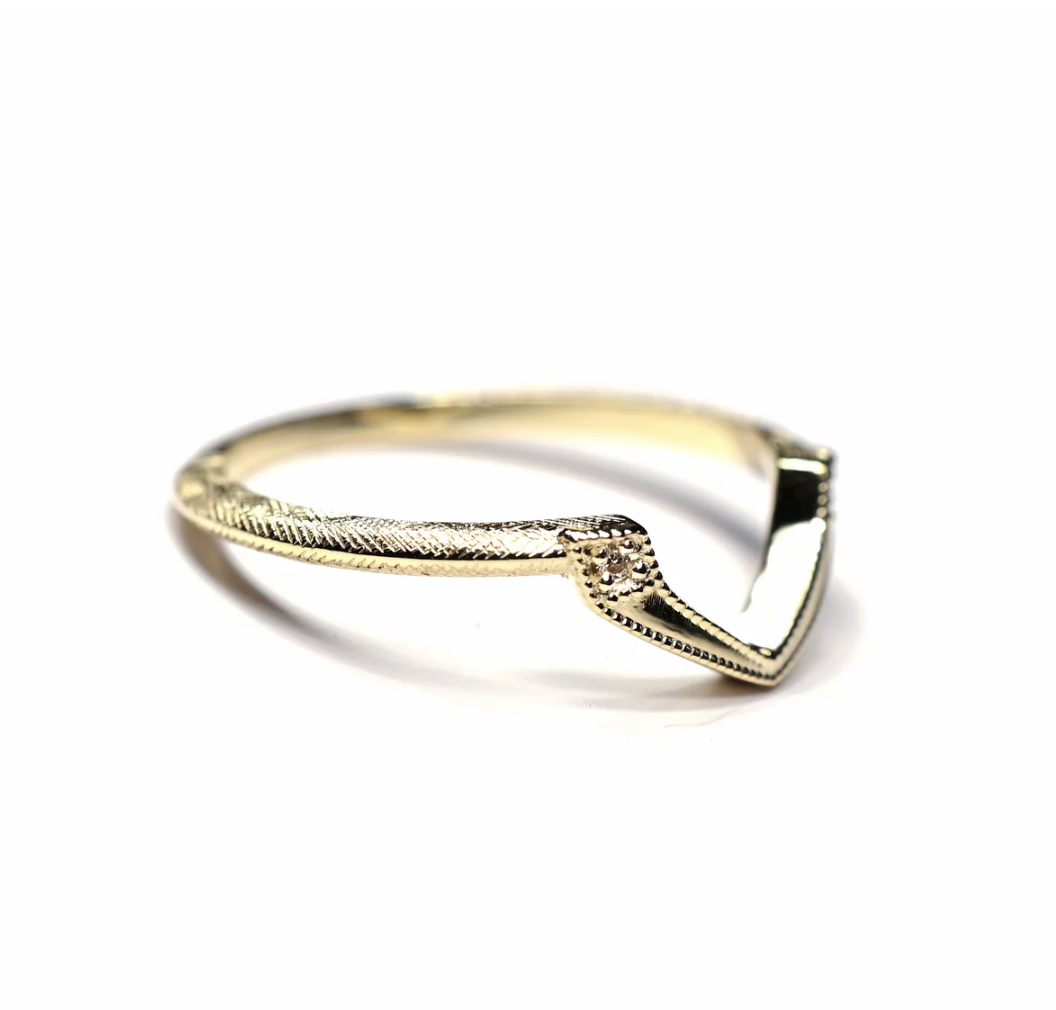 Gold ring with a unique design on a white background