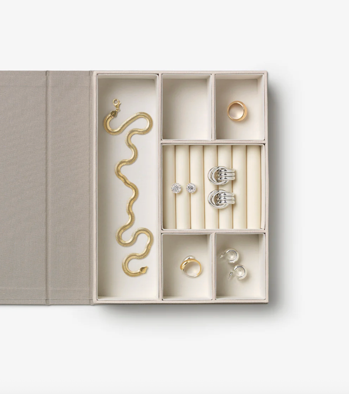 Jewelry organizer with necklaces, rings, and earrings on a white background