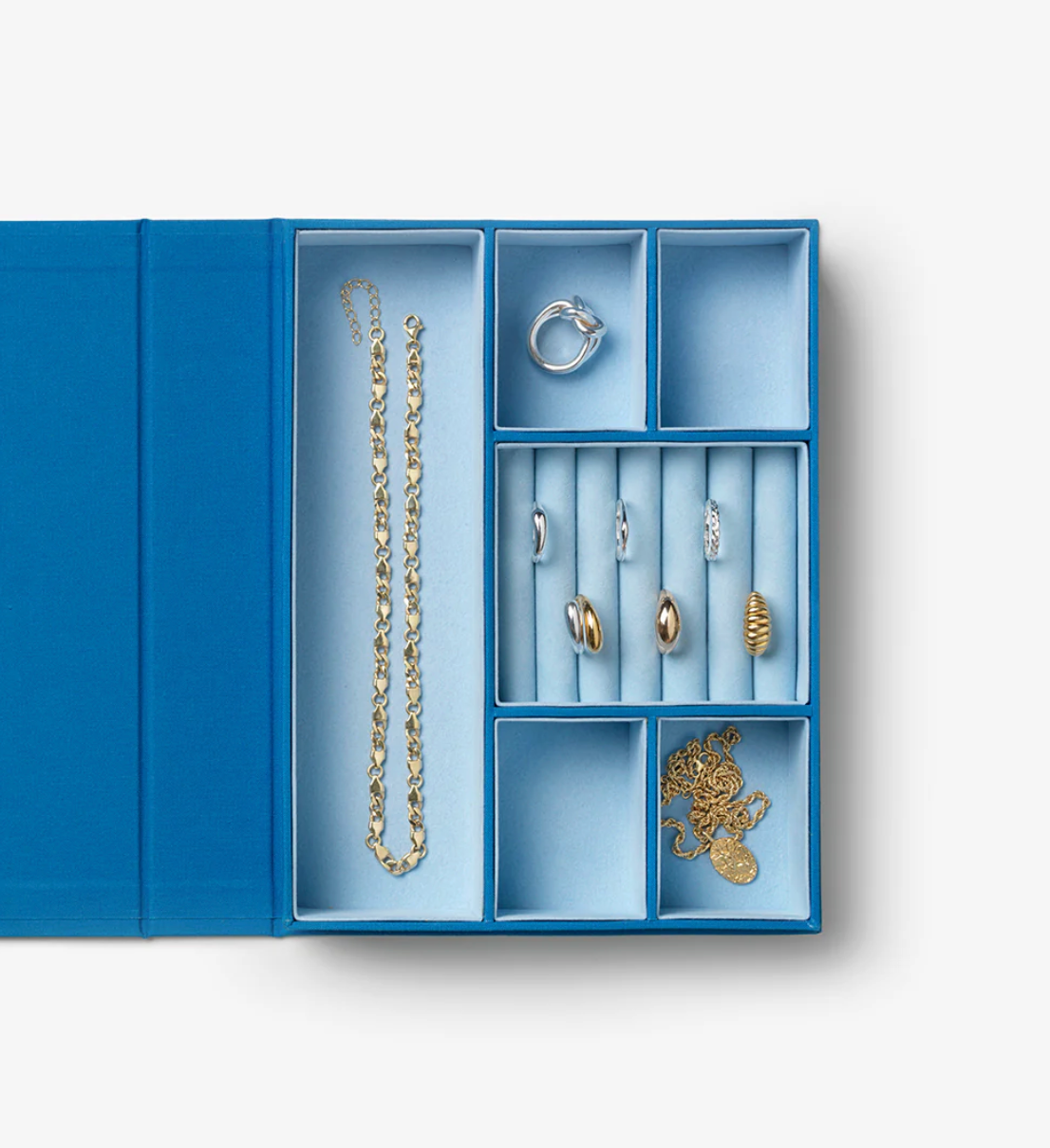Blue jewelry organizer with compartments holding necklaces, rings, and earrings on a white background