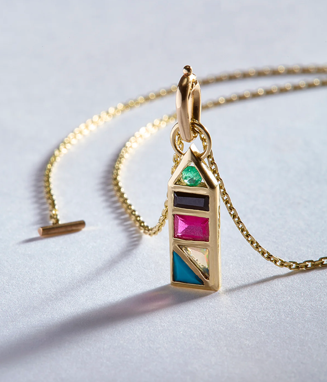 close up of the rainbow tableau roma pendant on grey background