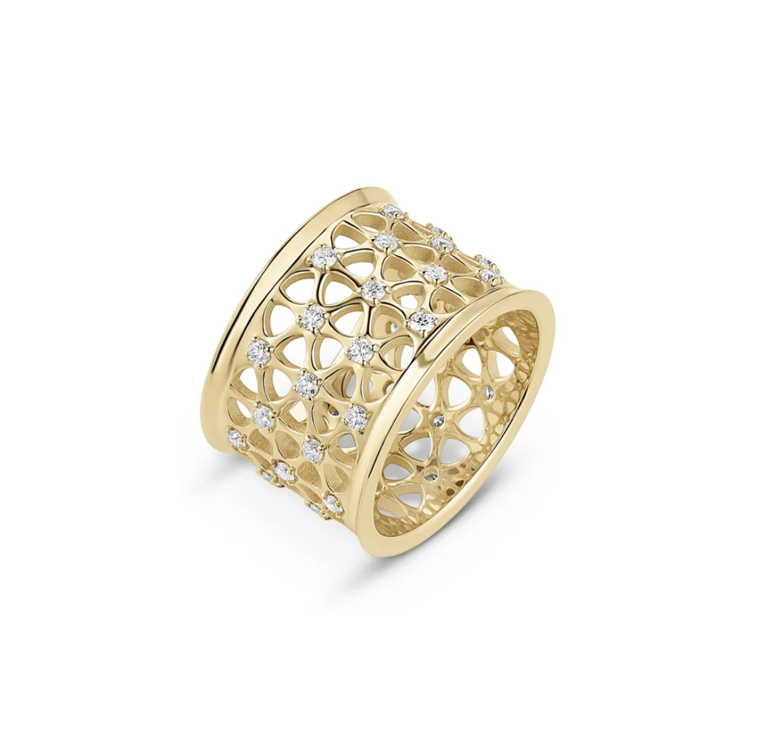 Gold ring with diamond accents on a white background
