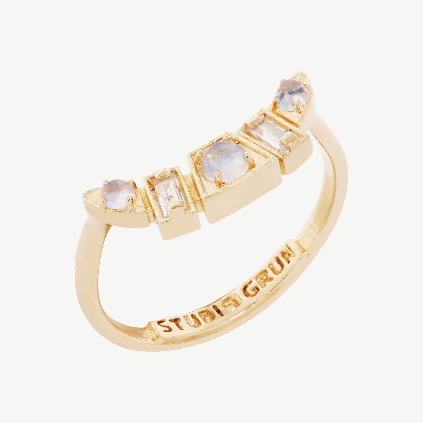 Gold ring with gemstones on a white background