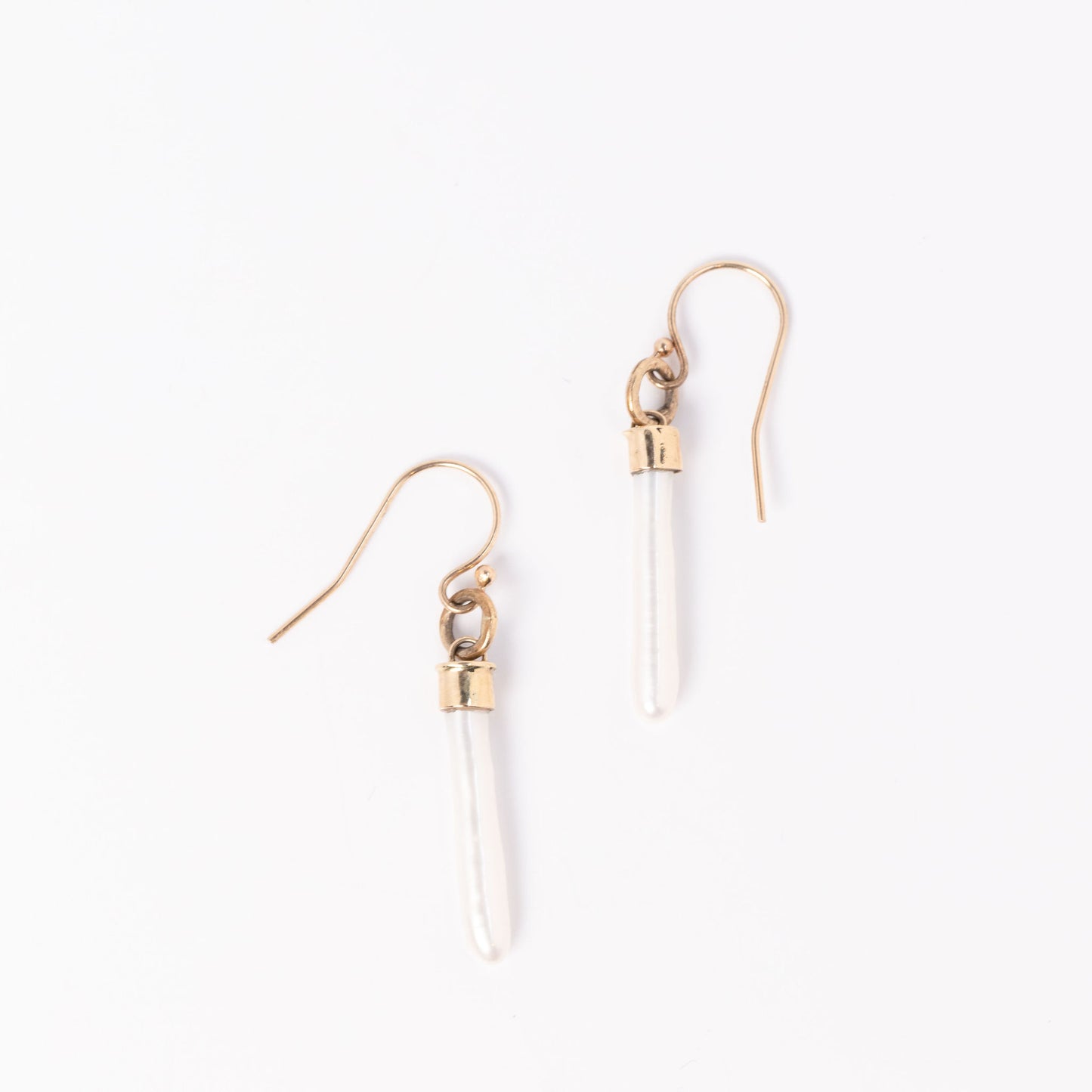 Cultivated white pearl stick earrings on white background