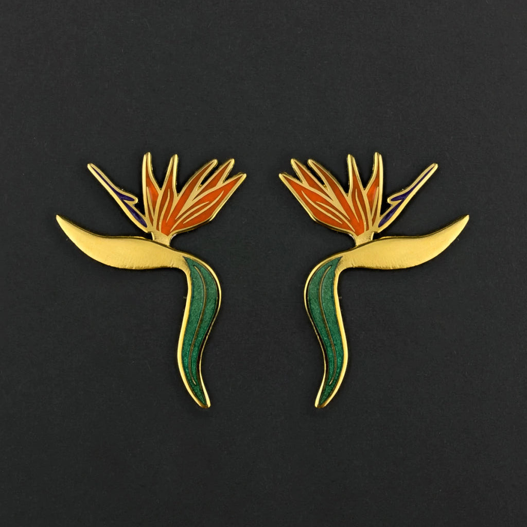 Pair of bird-of-paradise flower earrings on a black background