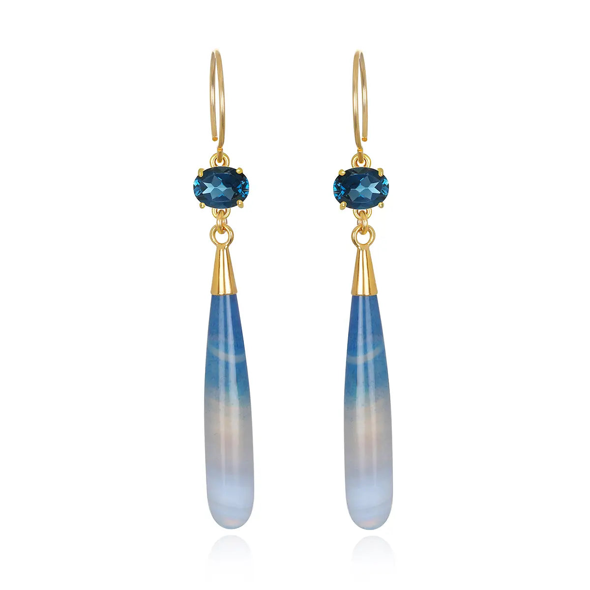 gold earrings with a dark london blue topaz prong set with a blue agate drop on a white background