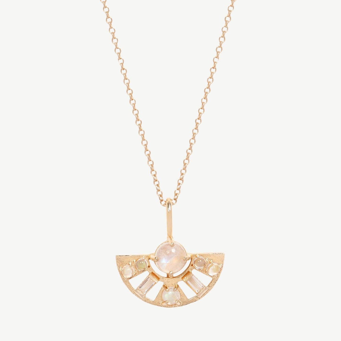Gold necklace with a half-circle pendant with round rainbow moonstone and baguette topaz on a white background