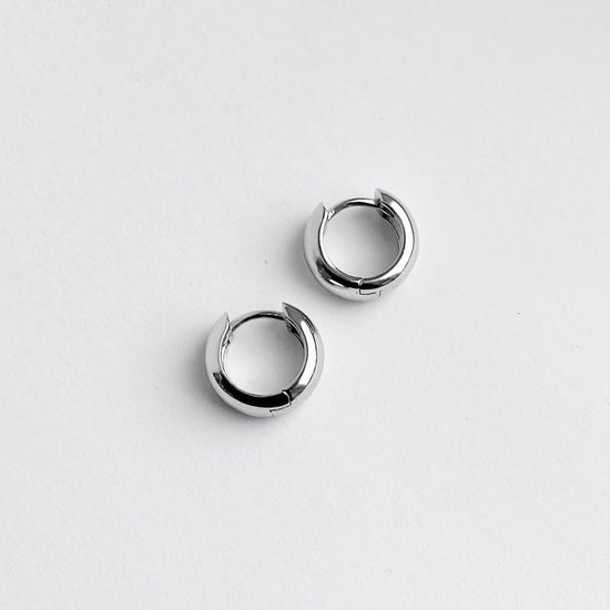 Pair of silver hoop earrings on a white background