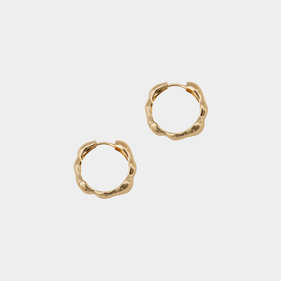 Gold hoop earrings on a white background