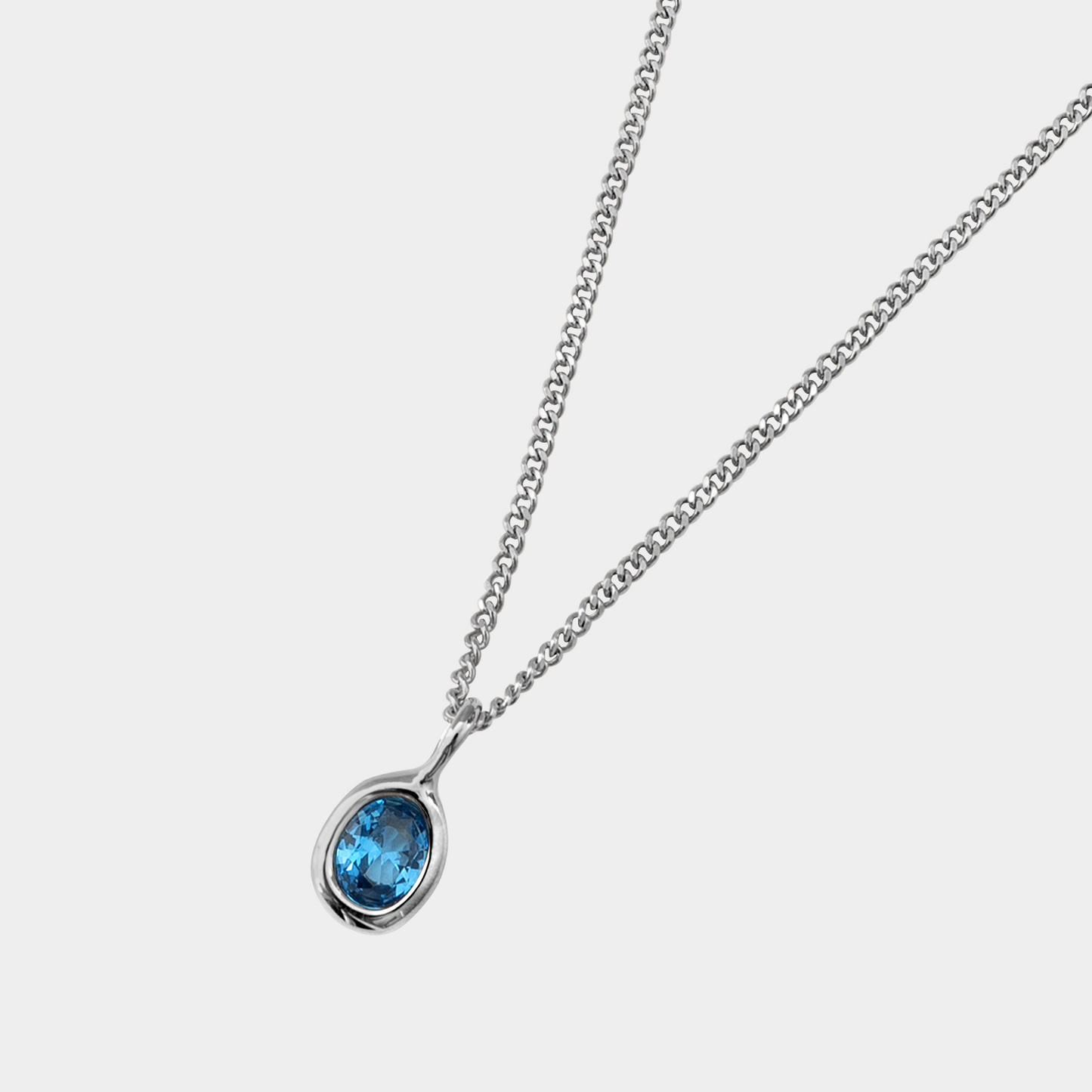 Necklace with a blue gemstone pendant on a white background