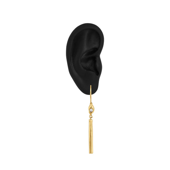 single illumination candle drop earring on a black silicone ear