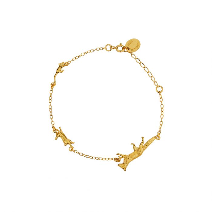 gold charm bracelet on a white background with a fox, rabbit, and mouse charm